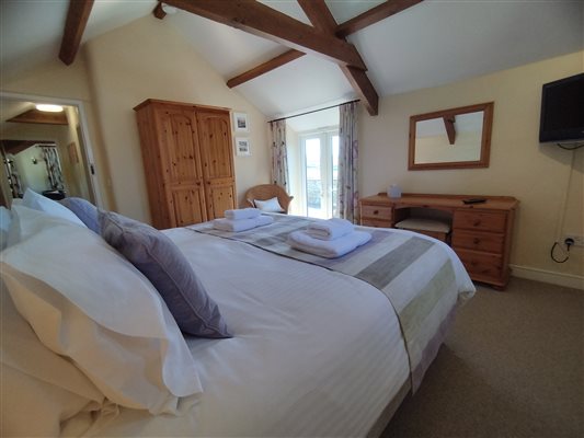 The Lodge bedroom with patio doors